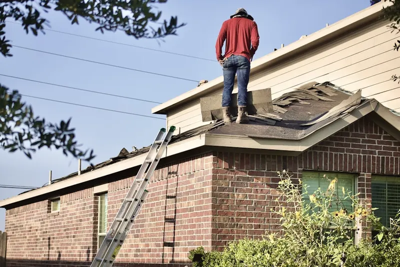 Professional roofer working on a residential roof in Hagerville